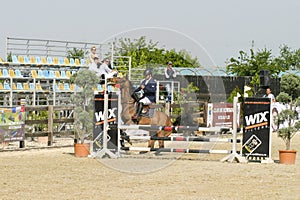 Equitation contest, horse refusing to jump over an obstacle