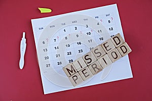 Missed period marked on calendar, pregnancy test. Woman`s health and delay in menstruation.