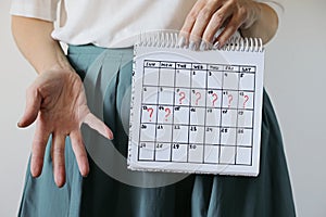 Missed period and marking on calendar. Unwanted pregnancy, woman`s health and delay in menstruation.