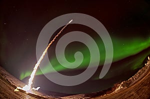 Missile launch at night with aurora polaris. photo