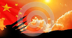 The missiles are aimed at the sky at sunset with China flag. Nuclear bomb, chemical weapons, missile defense.