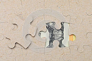 The missing element of the puzzle and the framed Moldovan lei MDL banknote. Background with copy space