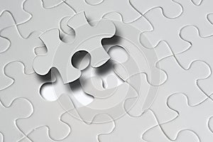 Missing jigsaw puzzle piece with light glow