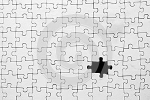 Missing piece in white jigsaw puzzle