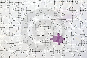 Missing piece in white jigsaw puzzle