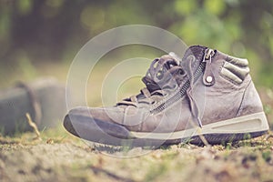 Missing and poverty concept: Abandoned shoe lying on the dusty ground