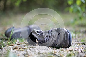 Missing and poverty concept: Abandoned shoe lying on the dusty ground