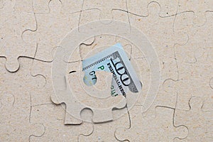 Missing puzzle piece and framed US dollars. Background with copy space
