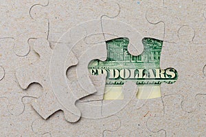 Missing puzzle piece and framed US dollars. Background with copy space