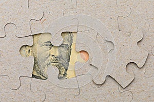 Missing puzzle piece and framed US dollars. Background with copy space