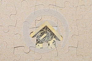 Missing puzzle piece and framed US dollars. Background with copy space