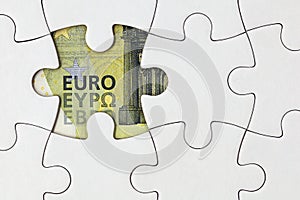 Missing puzzle piece shows a section of a euro banknote, concept for missing money in the pension fund or state budget