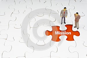 MISSION inscription written on jigsaw puzzle and businessman miniature