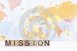 Mission Spelled in Blocks Against a Background of a World Map