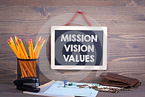 Mission, Vision and Values. Chalkboard on a wooden background photo