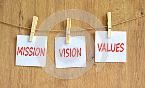 Mission vision values symbol. Concept words Mission Vision Values on white paper on clothespin on a beautiful wooden table wooden