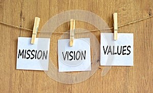 Mission vision values symbol. Concept words Mission Vision Values on white paper on clothespin on a beautiful wooden table wooden