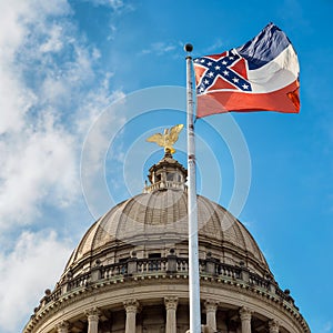Mississippi state flag flying in front of capitol building