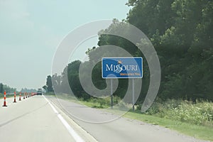 Missouri welcome sign on a highway, signaling state entry on a sunny day.