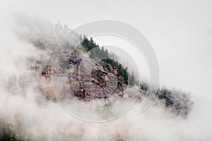 Mist Clouds and Fog Shroud this Colorado Rocky Mountain Bluff Face