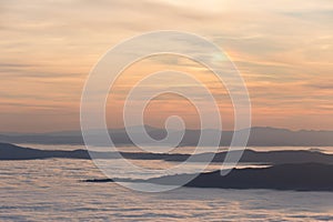 Mist and fog between valley and layers of mountains and hills at sunset, in Umbria Italy