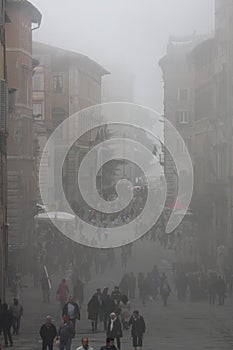 Mist morning fog in Perugia (Tuscany, Italy). People walking