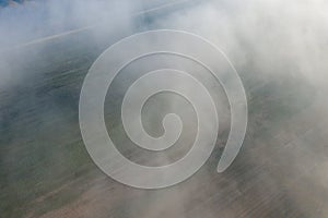 The mist over the fields in Europe, in France, in the Center region, in the Loiret, towards Orleans, in Winter, during a sunny day