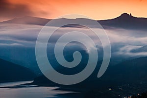 Mist over high mountain and lake