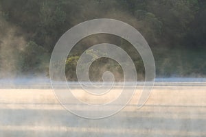 Mist Rising from Lake Water with Island and Forest of Trees