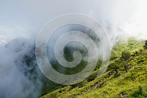 Mist running down a sunny hill in the mountain