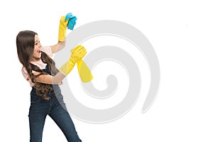 Mist sprayer helpful for wiping dust. Girl yellow rubber protective gloves ready for cleaning copy space. Household