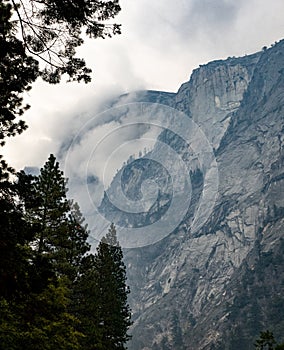 Mist surrounds the granite cliffs