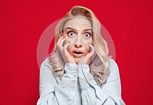 Mistake. Frightened young woman stare to you, isolated on white background