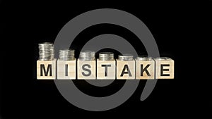 mistake - word of wooden blocks with letters on a black background. selective focus.