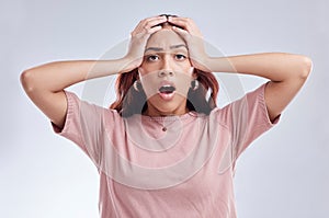 Mistake, wow and young woman in studio with hand on head for anxiety, stress or panic. Portrait of a shocked female