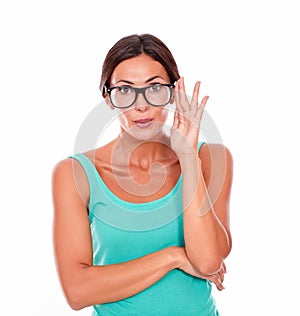 Mistaken caucasian woman touching her glasses photo