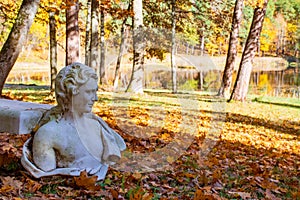 Mister autumn. Wonderful autumn landscape with beautiful old statue of a man