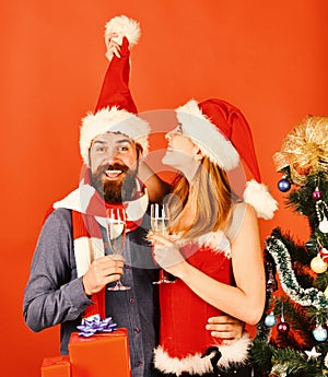 Mister and Missis Claus hold glasses of champagne.