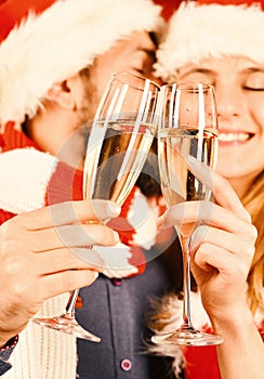 Mister and Missis Claus hold glasses of champagne, close up