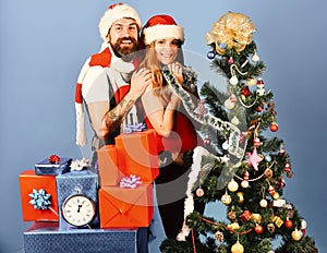 Mister and Missis Claus with red and blue gifts