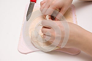 Mistress cooks pieces of boiled chicken