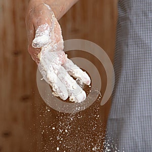 Mistress pours flour in the kitchen