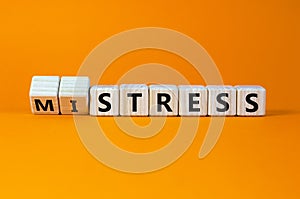Mistress or stress symbol. Turned wooden cubes and changed the word `mistress` to `stress`. Beautiful orange background. Mistr
