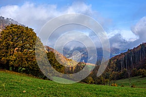 Misty autumn landscape with forest and rock. Blue sky with beautiful clouds. Vrsatec, Slovakia.