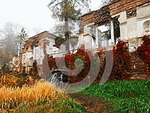 Misty autumn landscape with Ruins and waterfall in park