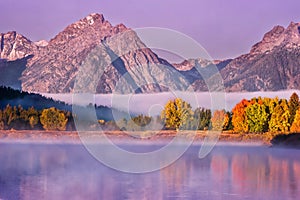 A misty autumn morning at Oxbow Bend in the Snake River, in Grand Teton National Park.