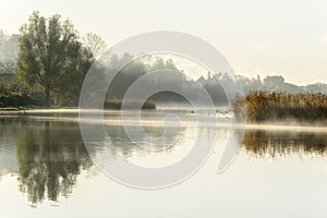 Misty autumn morning with reflections in the water