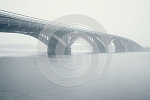 Misty cityscape, bridge and Dnieper river in dense fog, Kiev, Ukraine