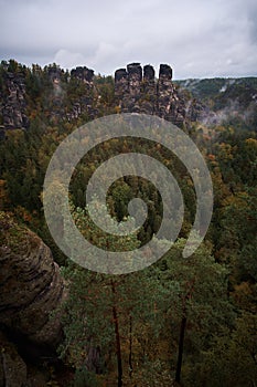 Misty fog mountains from viewpoint of Bastei in Saxon Switzerland, Germany to the mountains at sunrise in the morning fog