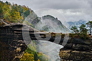 Misty foggy landscape of the Pravcicka gate Pravcicka brana the largest natural sandstone arch in Europe in Czech Switzerland